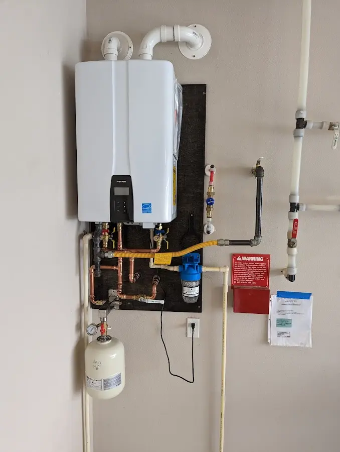 Professional plumber installing copper piping in a Spring Hill home